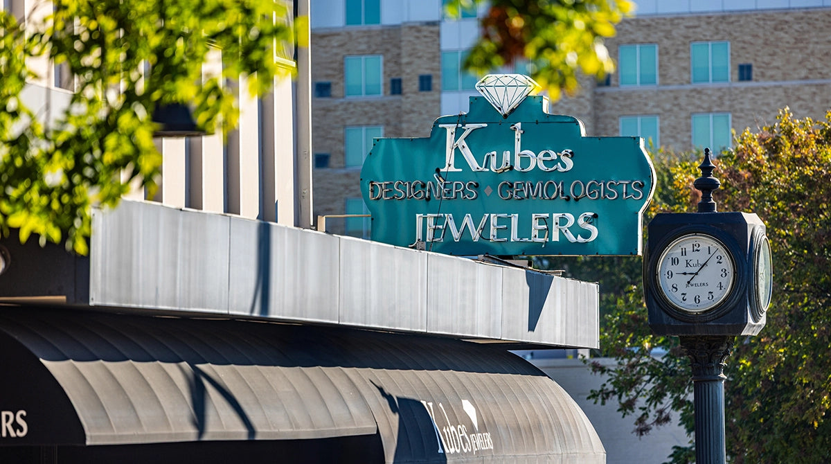Kubies Jewelers sign with a clock in front of a building